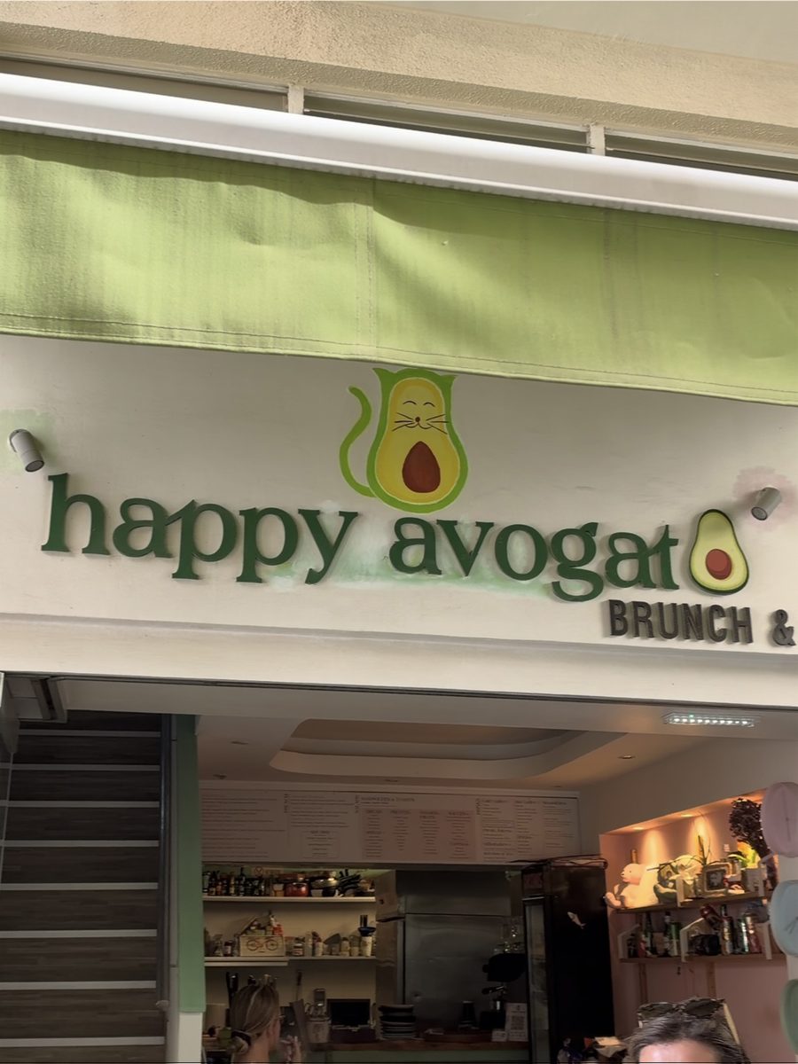Happy Avogato brunch cafe sign with an avocado cat logo in Larnaca, Cyprus