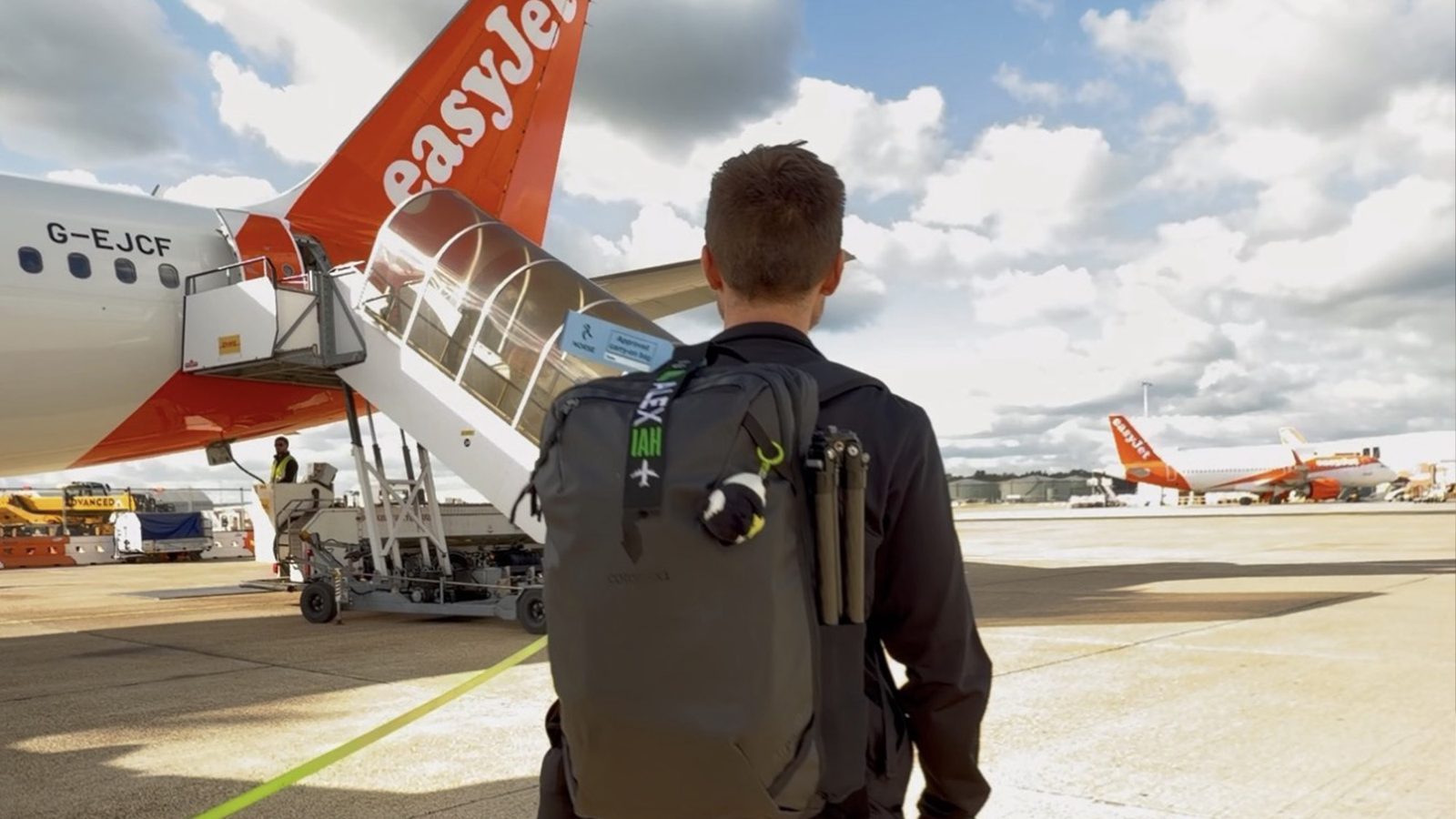 Alex walking across the tarmac to board an easyJet plane at London Gatwick
