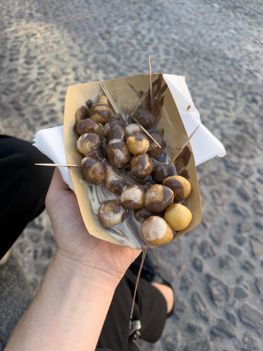 Chocolate loukoumades with milk and white chocolate sauce from La Petite in Fira, Santorini