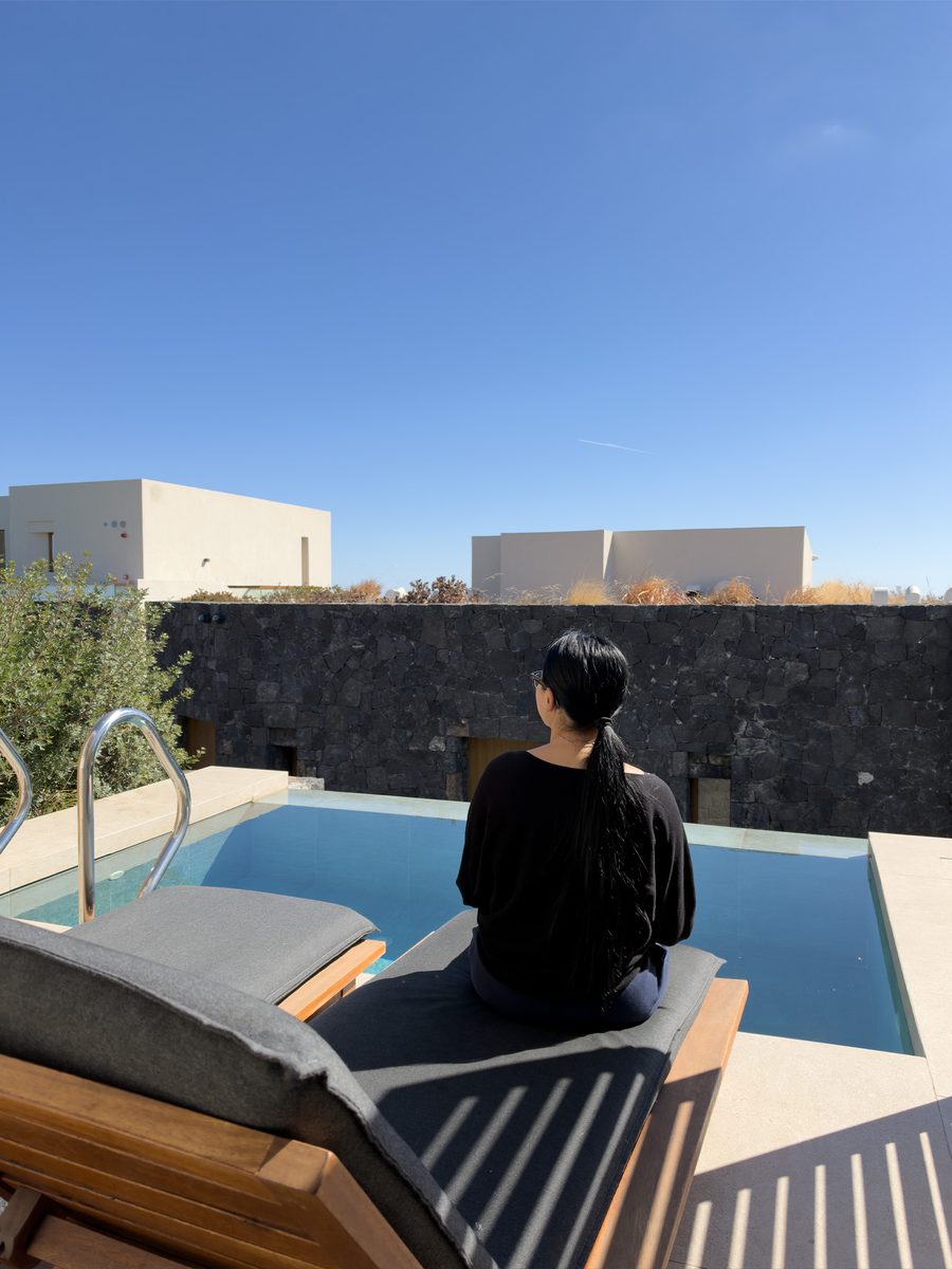 Megan relaxing by the private hot tub on our terrace at Magma Resort Santorini