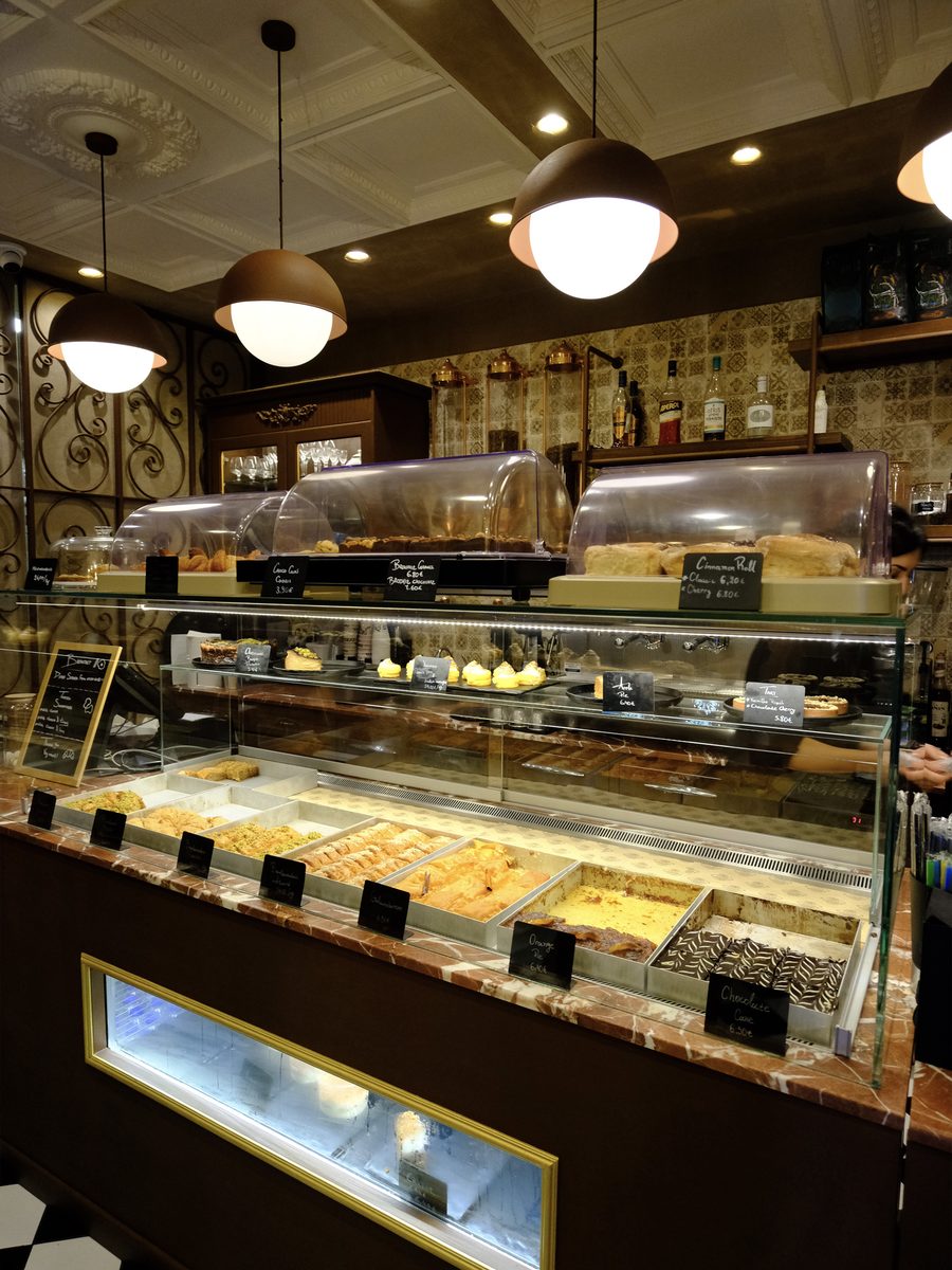 Pastry counter with baklava, cakes and cinnamon rolls at Phyllon bakery in Oia, Santorini