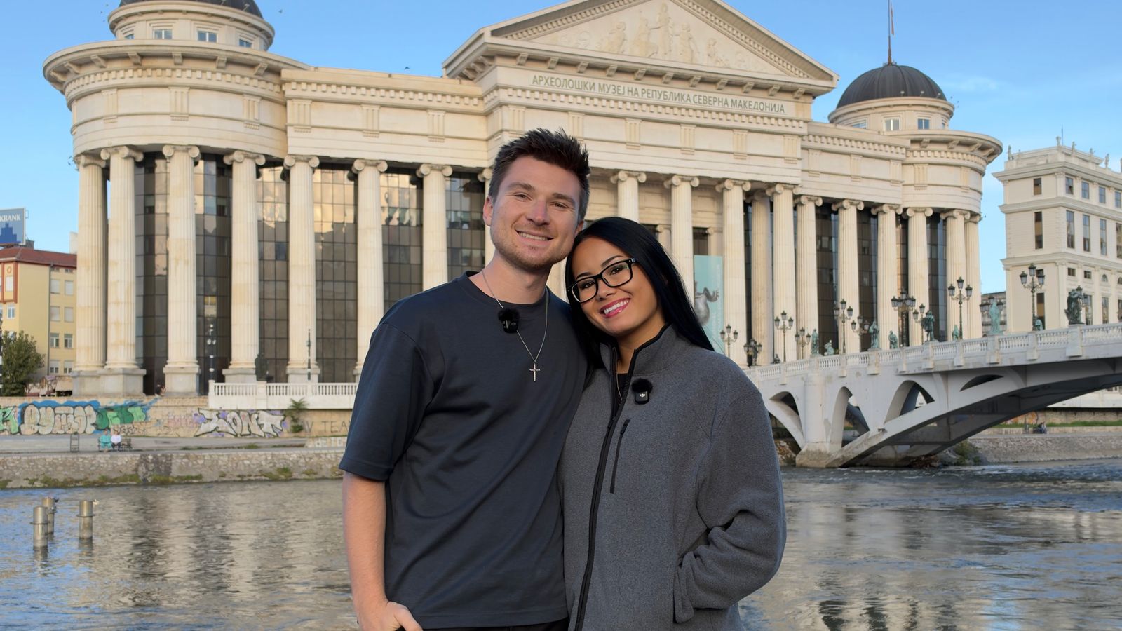 Alex and Megan Colhoun in front of the Archaeological Museum of North Macedonia and the Vardar River in Skopje
