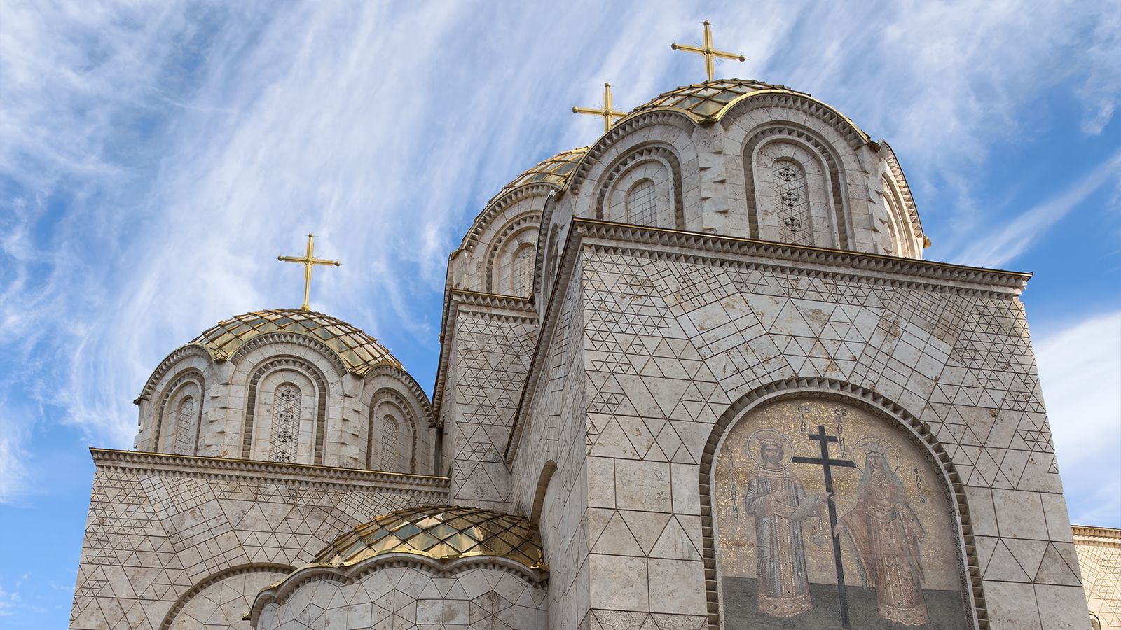 Church of Saints Constantine and Helena in central Skopje with gold domes and a mosaic above the entrance