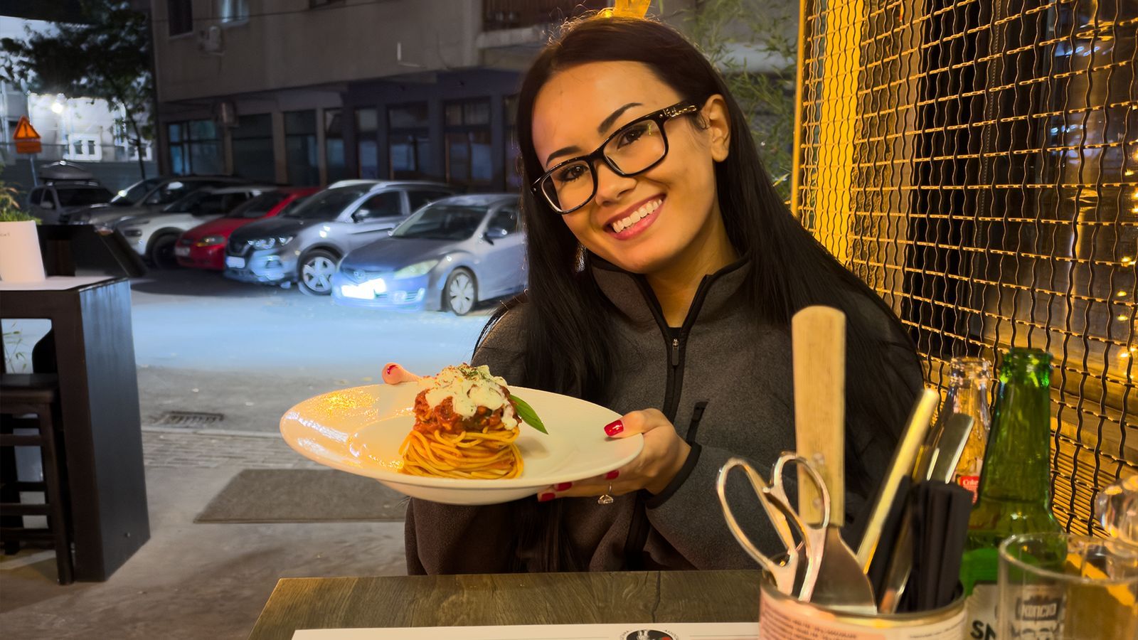 Megan holding a plate of spaghetti at Trattoria Matto Napoletano in Skopje